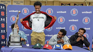 Stepinac High School basketball star Jasiah Jervis unveils a Michigan State University t-shirt as he announces which college he will be attending and playing basketball at during a ceremony at Stepinac High School in White Plains Nov. 5, 2025. With Jasiah was his mother Falana, his father Rhodes, and brother Jafari.