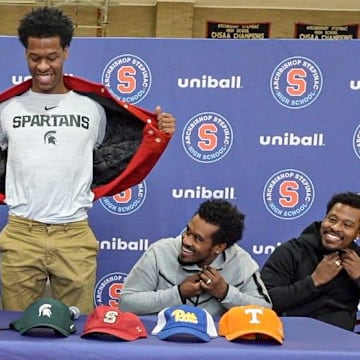 Stepinac High School basketball star Jasiah Jervis unveils a Michigan State University t-shirt as he announces which college he will be attending and playing basketball at during a ceremony at Stepinac High School in White Plains Nov. 5, 2025. With Jasiah was his mother Falana, his father Rhodes, and brother Jafari.
