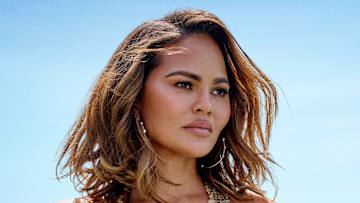 Chrissy Teigen was photographed by Yu Tsai in Los Angeles. Swimsuit by Natalia Fedner. Earrings by Jacquie Aiche. 