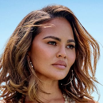 Chrissy Teigen was photographed by Yu Tsai in Los Angeles. Swimsuit by Natalia Fedner. Earrings by Jacquie Aiche. 