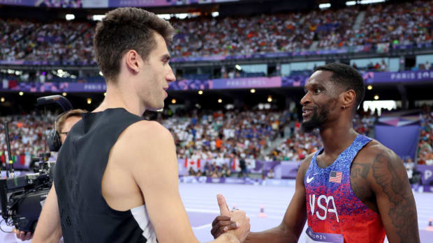 High jumpers Hamish Kerr and Shelby McEwen shake hands after finishing a jump-off at the Paris Olympics.