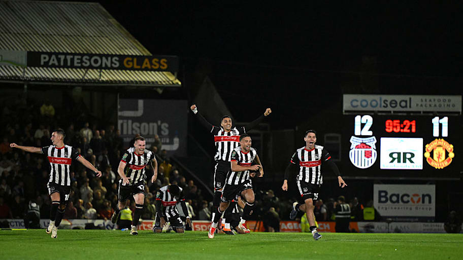 Grimsby Town players celebrate defeating Manchester United