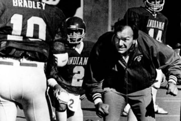 Indiana football coach Sam Wyche gives instructions to his team, including quarterback Steve Bradley (10).