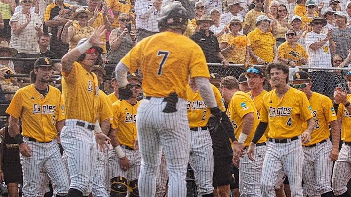 Southern Miss outfielder Ben Higdon celebrates with his teammates after hitting a home run at Pete Taylor Park.