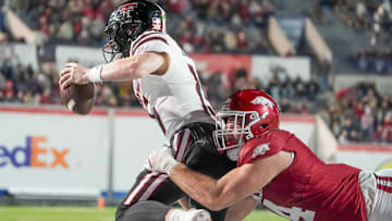 Texas Tech's Will Hammond (15) is sacked by Arkansas' Anton Juncaj (4) in the end zone for a safety during the AutoZone Liberty Bowl.