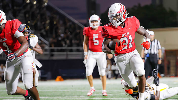 Milton (Georgia) running back TJ Lester escapes an American Heritage (Florida) tackler.