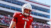 Oct 4, 2025; Raleigh, North Carolina, USA; NC State Wolfpack quarterback CJ Bailey (11), linebacker Caden Fordham (1), wide receiver Keenan Jackson (8) and offensive lineman Jr. Anthony Carter (75) walk out for the coin toss prior to the first half of the game against Campbell Fighting Camels at Carter-Finley Stadium. Mandatory Credit: Jaylynn Nash-Imagn Images
