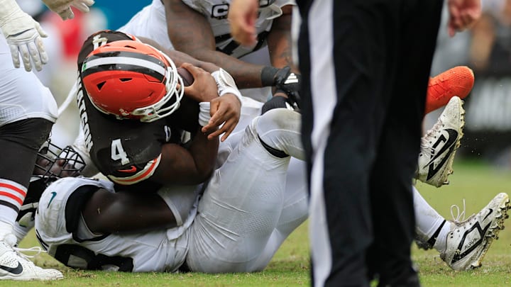 Cleveland Browns quarterback Deshaun Watson (4) is sacked by Jacksonville Jaguars linebacker Foyesade Oluokun (23) during the third quarter of an NFL football matchup Sunday, Sept. 15, 2024 at EverBank Stadium in Jacksonville, Fla. The Browns defeated the Jaguars 18-13. [Corey Perrine/Florida Times-Union]