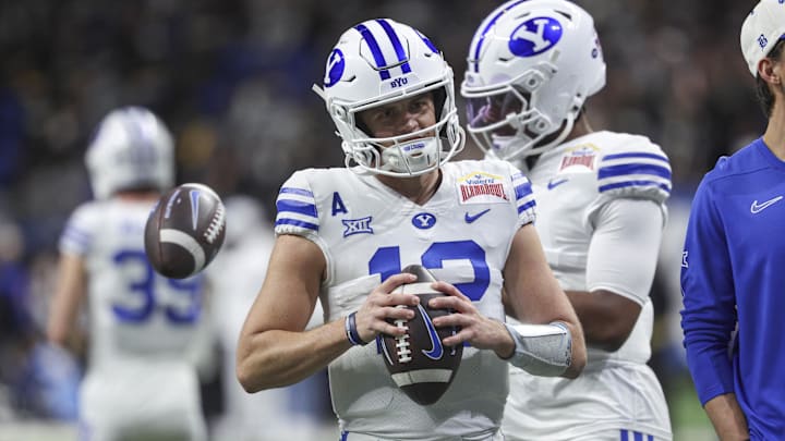 Dec 28, 2024; San Antonio, TX, USA; Brigham Young Cougars quarterback Jake Retzlaff (12) warms up before the game against the Colorado Buffaloes at Alamodome. Mandatory Credit: Troy Taormina-Imagn Images