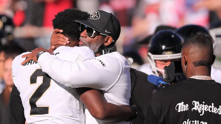 Colorado football coach Deion Sanders hugs his son, Shedeur Sanders.
