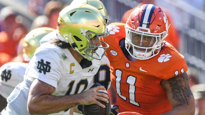 Notre Dame quarterback Sam Hartman (10) runs by Clemson defensive lineman Peter Woods (11) for a touchdown during the third quarter at Memorial Stadium in Clemson, S.C. Saturday, November 4, 2023.