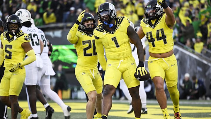 Oct 4, 2024; Eugene, Oregon, USA; Oregon Ducks defensive end Jordan Burch (1) celebrates with teammates linebacker Bryce Boettcher (28) and linebacker Teitum Tuioti (44) after recovering a fumble for a safety during the first half against the Michigan State Spartans at Autzen Stadium. Mandatory Credit: Troy Wayrynen-Imagn Images