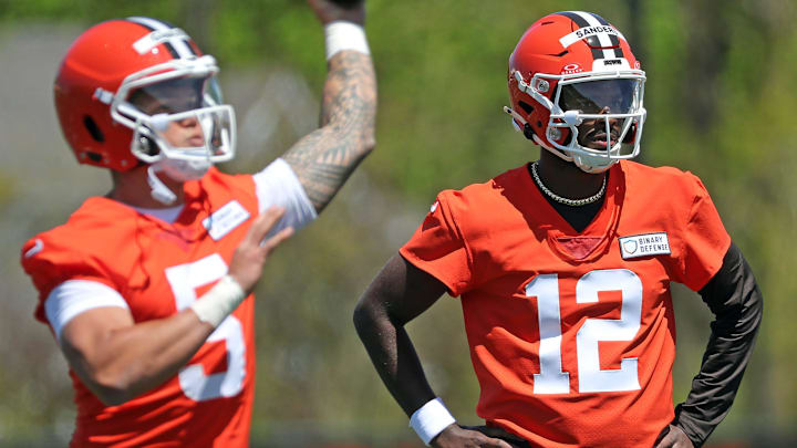 Cleveland Browns quarterback Shedeur Sanders (12) watches as quarterback Dillon Gabriel (5) throws during NFL rookie minicamp at the Cleveland Browns training facility on Friday, May 9, 2025, in Berea, Ohio.