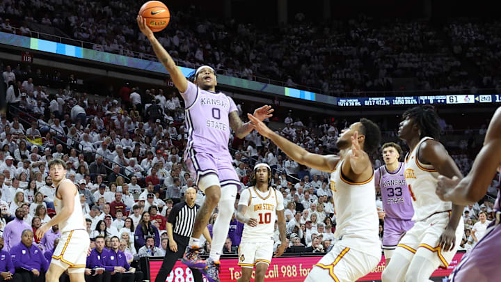 Feb 1, 2025; Ames, Iowa, USA; Kansas State Wildcats guard Dug McDaniel (0) splits the Iowa State Cyclones defense during the second half at James H. Hilton Coliseum. Mandatory Credit: Reese Strickland-Imagn Images