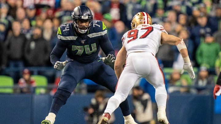 December 29, 2019; Seattle, Washington, USA; Seattle Seahawks offensive tackle George Fant (74) against San Francisco 49ers defensive end Nick Bosa (97) during the fourth quarter at CenturyLink Field.