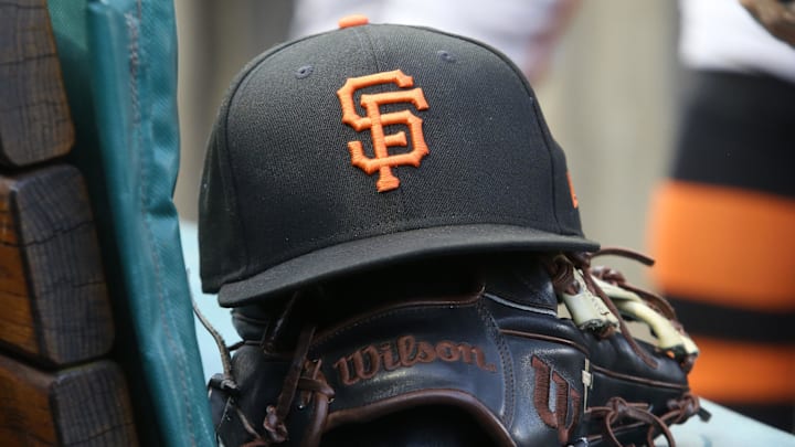 Jul 14, 2023; Pittsburgh, Pennsylvania, USA;  San Francisco Giants hat and glove on the bench against the Pittsburgh Pirates during the first inning at PNC Park. Mandatory Credit: Charles LeClaire-Imagn Images