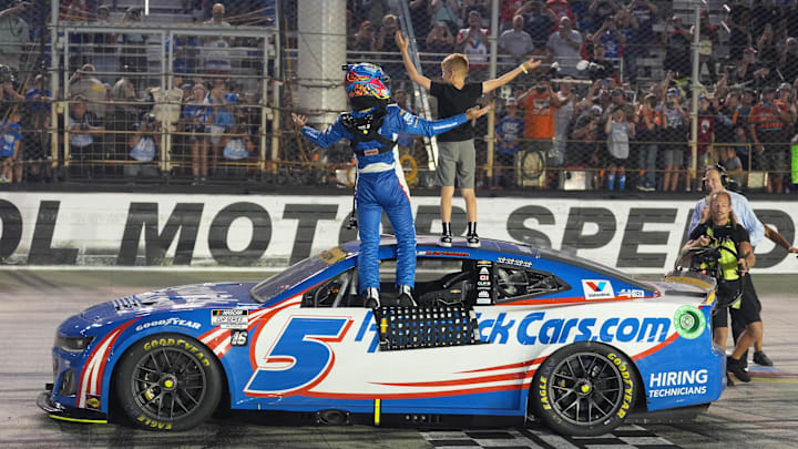 Sep 21, 2024; Bristol, Tennessee, USA; NASCAR Cup Series driver Kyle Larson (5) and his son Owen after winning the Bass Pro Shops Night Race at Bristol Motor Speedway. 
