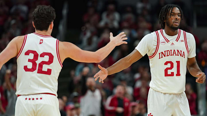 Indiana Hoosiers guard Trey Galloway (32) high-fives forward Mackenzie Mgbako (21) against Harvard at Gainbridge Fieldhouse.