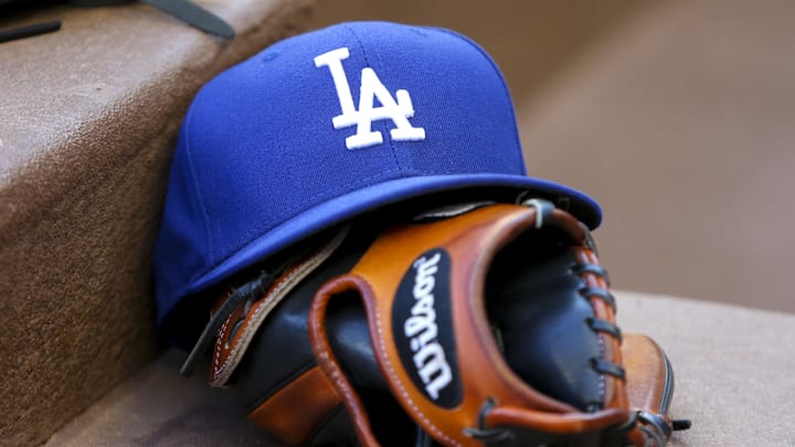 Aug 16, 2019; Atlanta, GA, USA; Detailed view of Los Angeles Dodgers hat and glove in the dugout against the Atlanta Braves in the first inning at SunTrust Park. Mandatory Credit: Brett Davis-Imagn Images