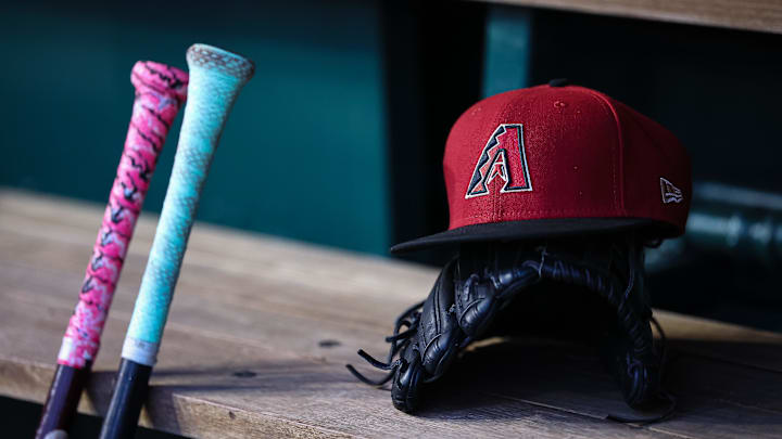 Jun 7, 2023; Washington, District of Columbia, USA; A general view of an Arizona Diamondbacks hat, glove, and bats in the dugout during the fifth inning of the game against the Washington Nationals at Nationals Park. Mandatory Credit: Scott Taetsch-Imagn Images