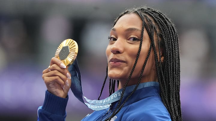 Aug 9, 2024; Saint-Denis, FRANCE; Gold medalist Tara Davis-Woodhall (USA) celebrates during the medal ceremony for the women's long jump during the Paris 2024 Olympic Summer Games at Stade de France. Aug 9, 2024; Saint-Denis, FRANCE; Gold medalist Tara Davis-Woodhall (USA) celebrates during the medal ceremony for the women's long jump during the Paris 2024 Olympic Summer Games at Stade de France.