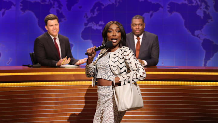 SATURDAY NIGHT LIVE -- Episode 1884 -- Pictured: (l-r) Anchor Colin Jost, Ego Nwodim as Miss Eggy, and anchor Michael Che during Weekend Update on Saturday, May 17, 2025 -- (Photo by: Will Heath/NBC)