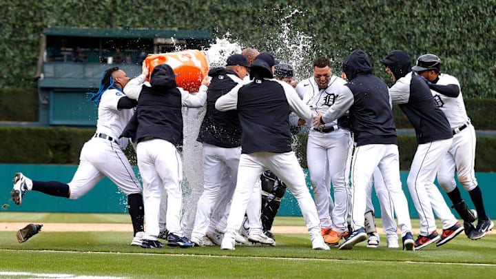Detroit Tiger teammates celebrate with Javier Baez after he hit a single off the right field wall.