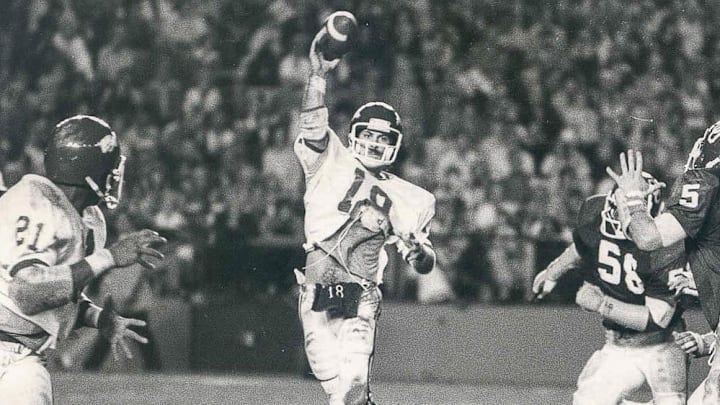 Arkansas Razorbacks quarterback Ron Calcagni (18) throws a screen to running back Roland Sales (21) in the Orange Bowl against Oklahoma  on Jan. 2, 1978.