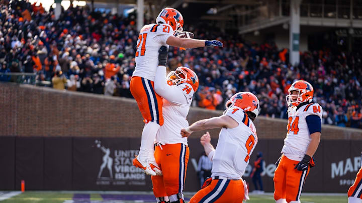 Illinois running back Aidan Laughery (21) is lifted up by offensive lineman J.C. Davis as teammates celebrate one of Laughery's three touchdowns against Northwestern in the Illini's 38-28 win Saturday at Wrigley Field in Chicago. Illinois running back Aidan Laughery (21) is lifted up by offensive lineman J.C. Davis as teammates celebrate one of Laughery's three touchdowns against Northwestern in the Illini's 38-28 win Saturday at Wrigley Field in Chicago.