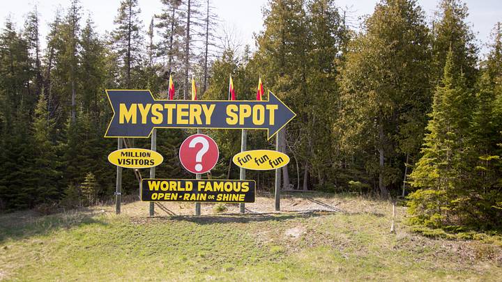 Sign reading "Mystery Spot" in the pine trees Sign reading "Mystery Spot" in the pine trees