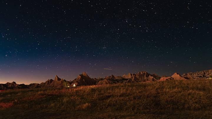 The Milky Way galaxy illuminates Badlands National Park in South Dakota.