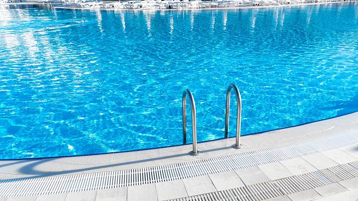 Blue swimming pool water with ladder going in Blue swimming pool water with ladder going in