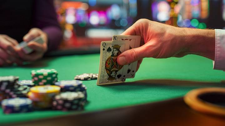 Close-up shot of hand holding a queen and king during poker game Close-up shot of hand holding a queen and king during poker game