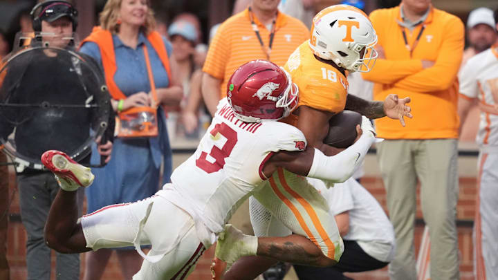Tennessee running back DeSean Bishop (18) is tackled by Arkansas defensive back Larry Worth III (3) during a college football game between Tennessee and Arkansas at Neyland Stadium in Knoxville, Tennessee on Oct. 11, 2025.