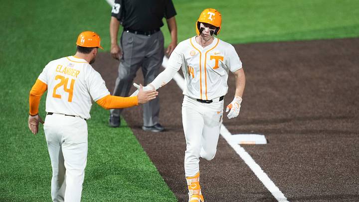 Tennessee's Blake Grimmer (14) high fives Tennessee coach Josh Elander as he runs home during a baseball game between Tennessee and Wright State in Lindsey Nelson Stadium in Knoxville, Tennessee, March 6, 2026.