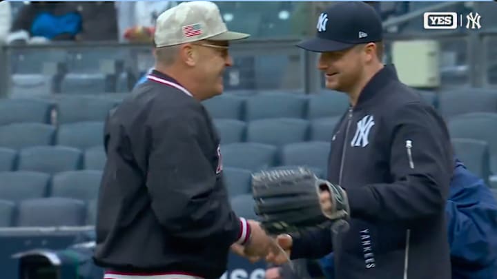 New York Yankees SP Clarke Schmidt and his father Dwight Schmidt embrace after Dwight threw out the ceremonial first pitch at Yankee Stadium.