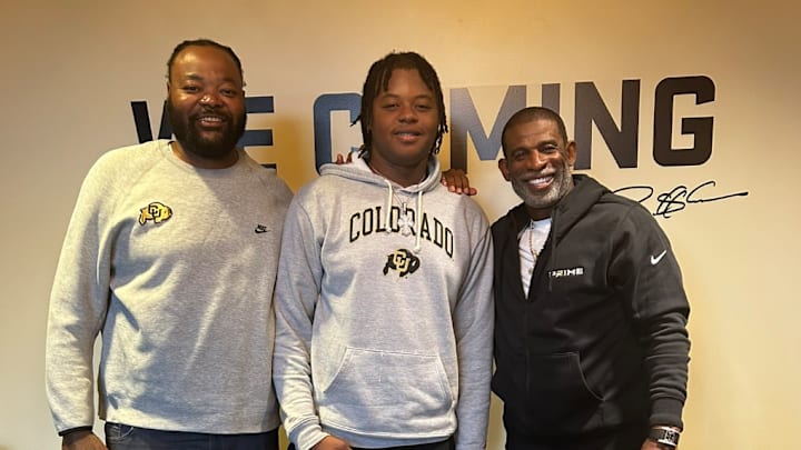 Four-star offensive tackle Carde Smith poses with Colorado head coach Deion Sanders during a September visit