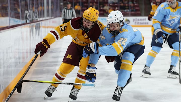 Gophers forward John Mittelstadt battling for the puck against Long Island.