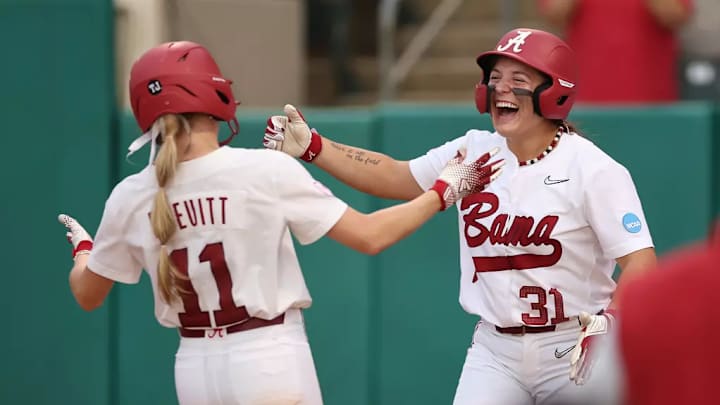 Alabama Softball Player Larissa Preuitt (11) and Alabama Softball Player Alexis Pupillo (31) hug against Jackson State during the NCAA Softball Tuscaloosa Regional at Rhodes Stadium in Tuscaloosa, AL on Friday, May 16, 2025.