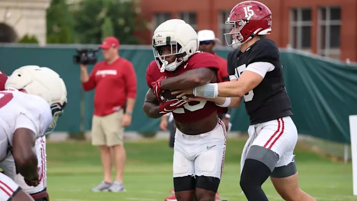 Jam Miller (26) takes a handoff from Ty Simpson (15). Jam Miller (26) takes a handoff from Ty Simpson (15).