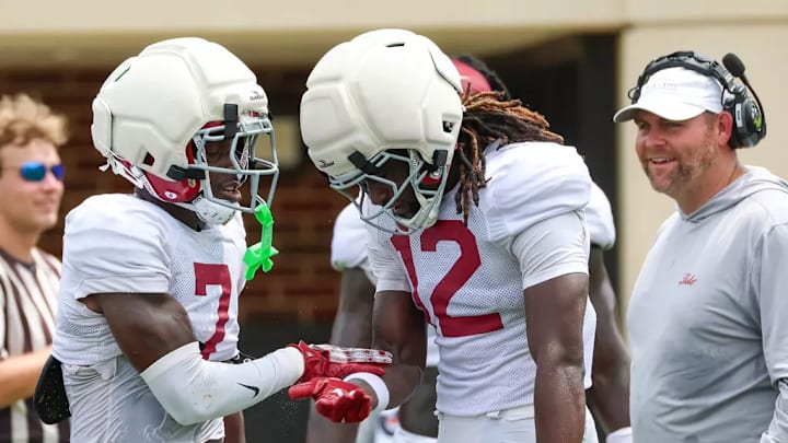 Alabama defensive coordinator Kane Wommack with Zay Mincey (12) and DaShawn Jones (7).