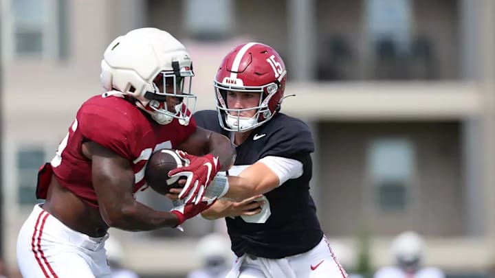 Jam Miller (26) takes a handoff from Ty Simpson. Jam Miller (26) takes a handoff from Ty Simpson.