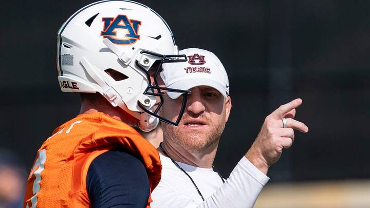 Auburn Tigers head coach Alex Golesh talks with quarterback Locklan Hewlett (3) during the first day of football practice at the Woltosz Football Performance Center in Auburn, Ala. on Wednesday, Aug. 5, 2026.