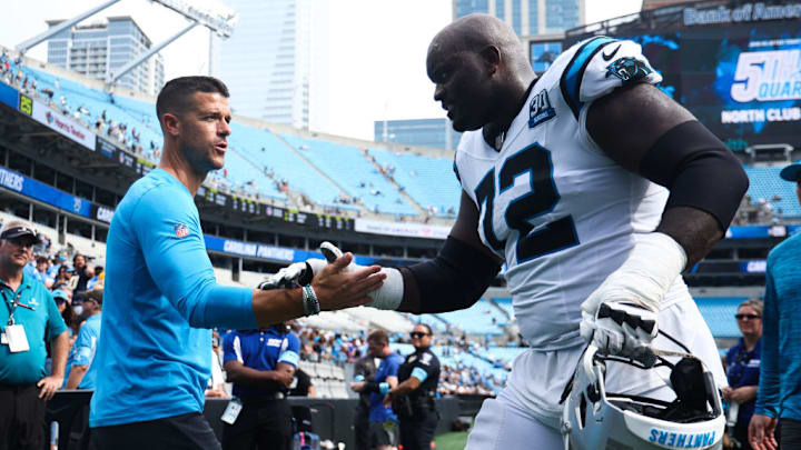 CHARLOTTE, NORTH CAROLINA - SEPTEMBER 15: Head coach Dave Canales and Taylor Moton #72 of the Carolina Panthers are seen after losing to the Los Angeles Chargers 26-3 at Bank of America Stadium on September 15, 2024 in Charlotte, North Carolina.