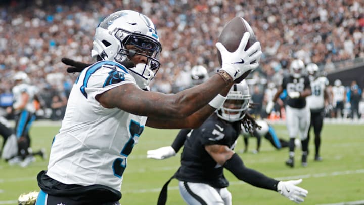 LAS VEGAS, NEVADA - SEPTEMBER 22: Diontae Johnson #5 of the Carolina Panthers catches a pass for a touchdown in front of Tre'von Moehrig #7 of the Las Vegas Raiders during the second quarter at Allegiant Stadium on September 22, 2024 in Las Vegas, Nevada.