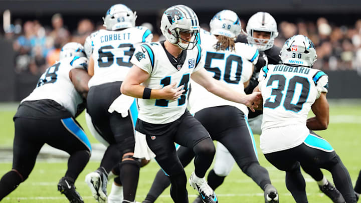 LAS VEGAS, NEVADA - SEPTEMBER 22: Quarterback Andy Dalton #14 hands the ball off to Chuba Hubbard #30 of the Carolina Panthers during the first quarter against the Las Vegas Raiders at Allegiant Stadium on September 22, 2024 in Las Vegas, Nevada.