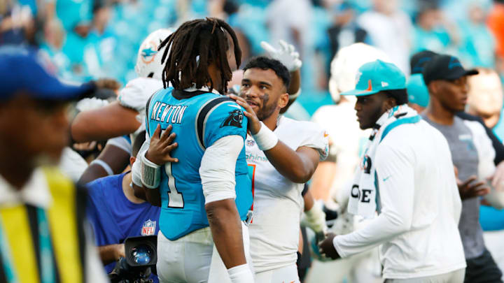 MIAMI GARDENS, FLORIDA - NOVEMBER 28: Cam Newton #1 of the Carolina Panthers and Tua Tagovailoa #1 of the Miami Dolphins embrace after their game at Hard Rock Stadium on November 28, 2021 in Miami Gardens, Florida. MIAMI GARDENS, FLORIDA - NOVEMBER 28: Cam Newton #1 of the Carolina Panthers and Tua Tagovailoa #1 of the Miami Dolphins embrace after their game at Hard Rock Stadium on November 28, 2021 in Miami Gardens, Florida.