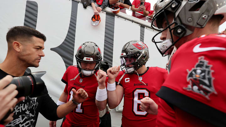 AMPA, FLORIDA - DECEMBER 24: John Wolford #11, Baker Mayfield #6 and Kyle Trask #2 of the Tampa Bay Buccaneers huddle before warmups prior to the game against the Jacksonville Jaguars at Raymond James Stadium on December 24, 2023 in Tampa, Florida. AMPA, FLORIDA - DECEMBER 24: John Wolford #11, Baker Mayfield #6 and Kyle Trask #2 of the Tampa Bay Buccaneers huddle before warmups prior to the game against the Jacksonville Jaguars at Raymond James Stadium on December 24, 2023 in Tampa, Florida.