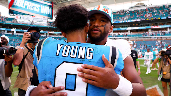 MIAMI GARDENS, FLORIDA - OCTOBER 15: Bryce Young #9 of the Carolina Panthers and Tua Tagovailoa #1 of the Miami Dolphins embrace after the game at Hard Rock Stadium on October 15, 2023 in Miami Gardens, Florida.