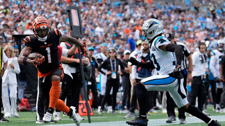 CHARLOTTE, NORTH CAROLINA - SEPTEMBER 29: Ja'Marr Chase #1 of the Cincinnati Bengals carries the ball past Troy Hill #13 of the Carolina Panthers during the third quarter at Bank of America Stadium on September 29, 2024 in Charlotte, North Carolina.